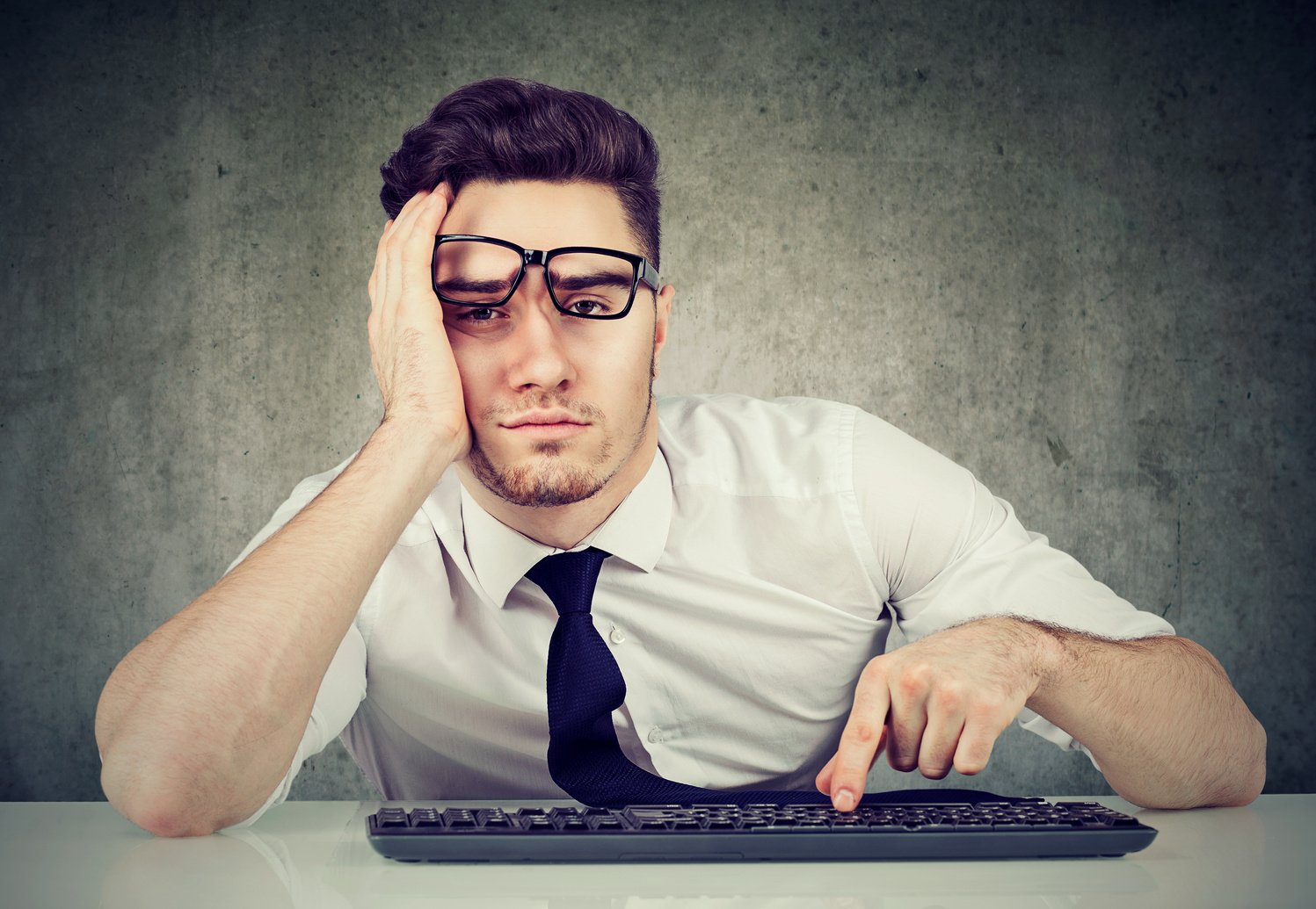 bored man employee sitting at desk has no motivation to work