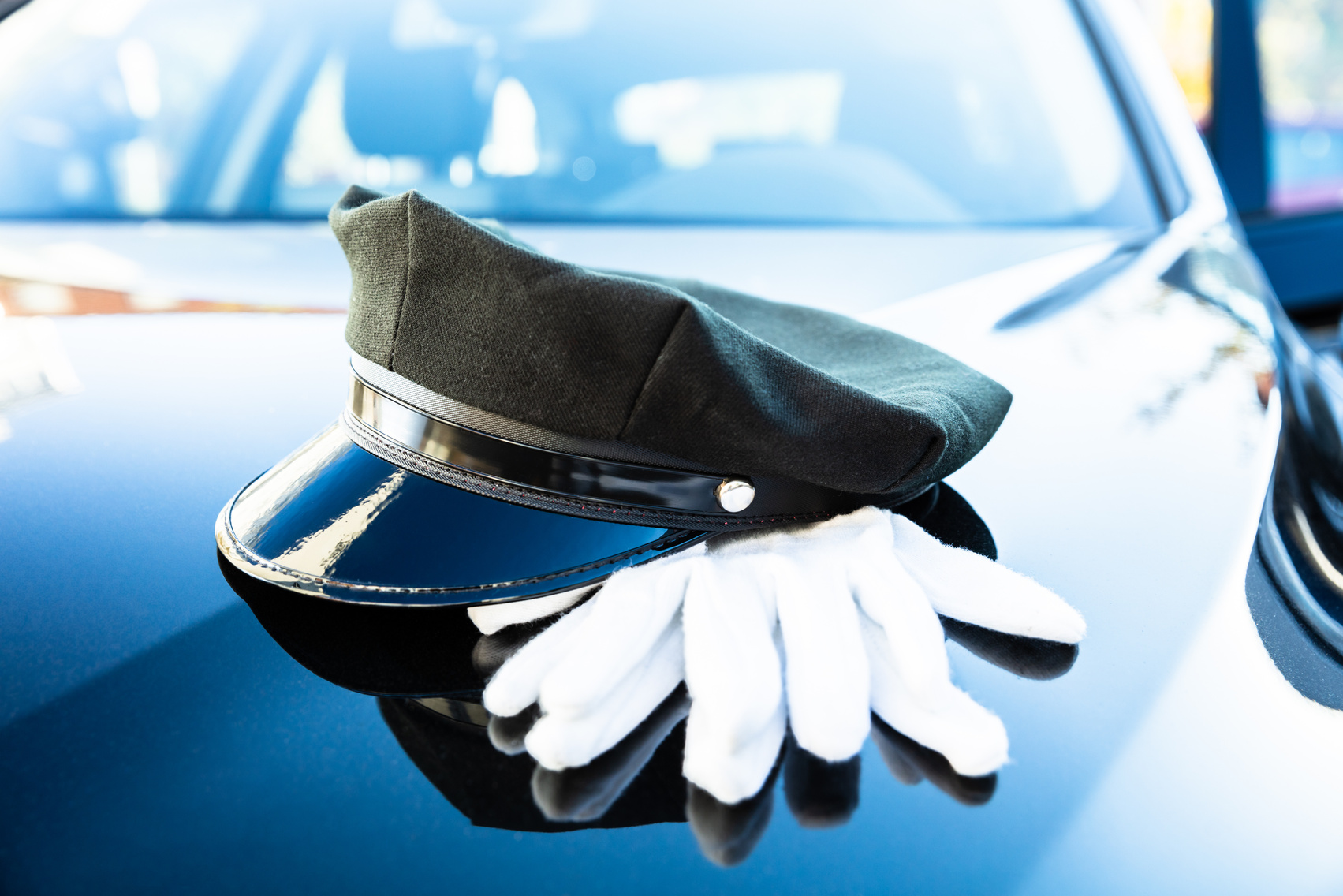 Chauffeur's Cap And Pair Of Gloves On Car Bonnet